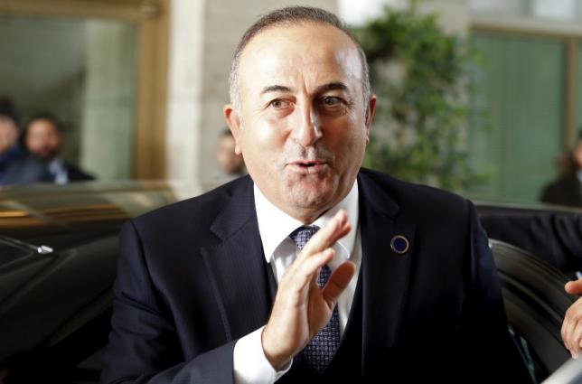 Turkey's Foreign Minister Mevlut Cavusoglu waves as he arrives for a meeting in Rome, Italy, December 13, 2015. REUTERS/Remo Casilli/Files