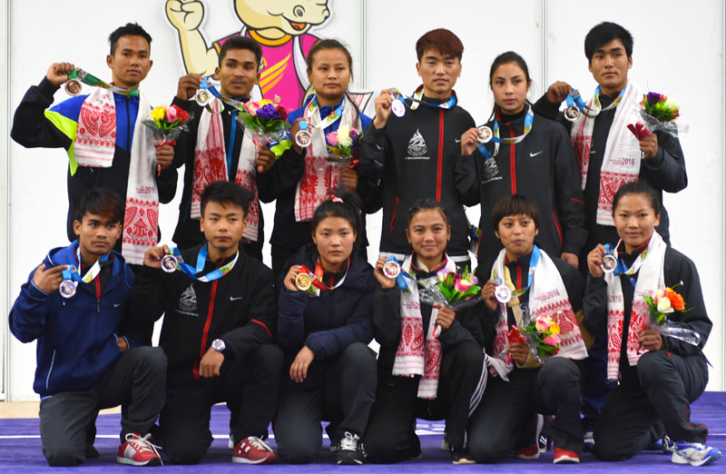 Nepal's winner wushukas players hold medals after their competitions, in the 12th South Asian Games, on Wednesday.