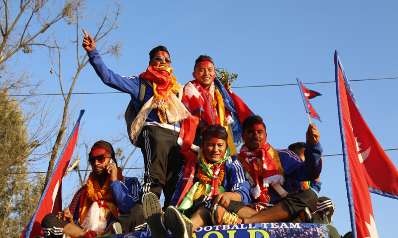 Footballers greet fans as the Nepal football team return home from the South Asian Games, during a victory rally in Kathmandu, on Wednesday, February 17, 2016. Photo: RSS