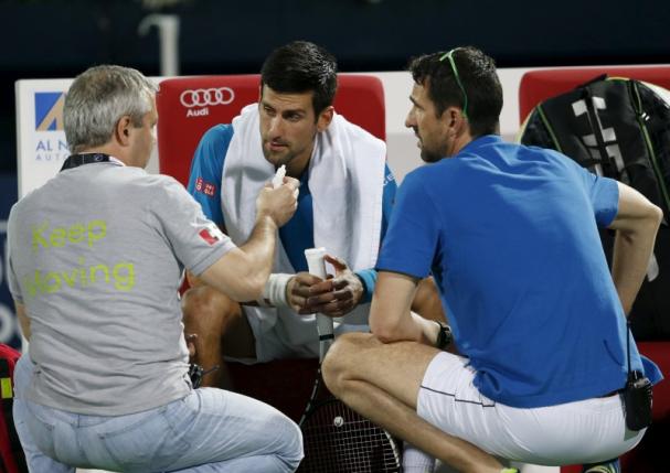 Novak Djokovic of Serbia receives treatment before withdrawing from his match against Feliciano Lopez of Spain at the ATP Dubai Duty Free Tennis Championships February 25, 2016. REUTERS/Ahmed Jadallah