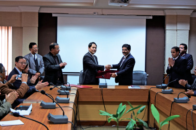 Baikuntha Aryal, Head of the International Economic Cooperation Coordination Division at the Ministry of Finance, and Takuya  Kamata, Country Manager of the World Bank Group to Nepal, exchanging files during a programme, in Kathmandu, on Thursday. Photo: THT