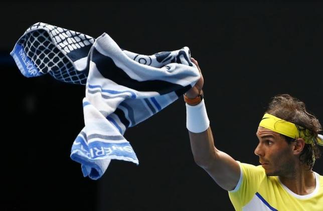 Spain's Rafael Nadal signals a ball boy to bring his other towel during his first round match against Spain's Fernando Verdasco at the Australian Open tennis tournament at Melbourne Park, Australia, January 19, 2016. REUTERS/Thomas Peter