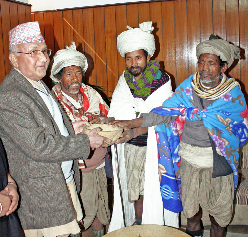 Members of Raute community girt a traditional wooden pot Prime Minister KP Sharma Oli at his official residence in Baluwatar, Kathmandu on Friday, February 12, 2016. Photo: PM Secretariatn