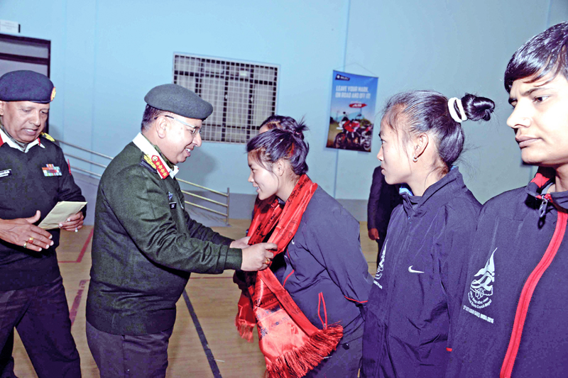 Chief of the Army Staff Gen Rajendra Chhetri felicitating 12th South Asian Games gold nmedallist wushu player Nima Gharti Magar in Lalitpur on Sunday, February 21, 2016. Photo: THT
