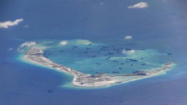 Chinese dredging vessels are purportedly seen in the waters around Mischief Reef in the disputed Spratly Islands in this still image from video taken by a P-8A Poseidon surveillance aircraft provided by the United States Navy May 21, 2015. REUTERS/U.S. Navy/Handout via Reuters/FilesnnATTENTION EDITORS - THIS PICTURE WAS PROVIDED BY A THIRD PARTY. REUTERS IS UNABLE TO INDEPENDENTLY VERIFY THE AUTHENTICITY, CONTENT, LOCATION OR DATE OF THIS IMAGE. THIS PICTURE IS DISTRIBUTED EXACTLY AS RECEIVED BY REUTERS, AS A SERVICE TO CLIENTS. EDITORIAL USE ONLY. NOT FOR SALE FOR MARKETING OR ADVERTISING CAMPAIGNS