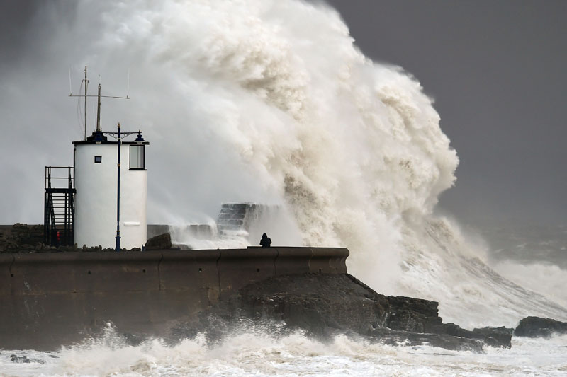 Waves crash over the sea wall at Porthcawl in Wales, on Monday February 8, 2016, as winds of nearly 100mph battered Britain after Storm Imogen slammed into the south coast bringing fierce gusts and torrential downpours. Photo: Joe Giddens/PA via AP