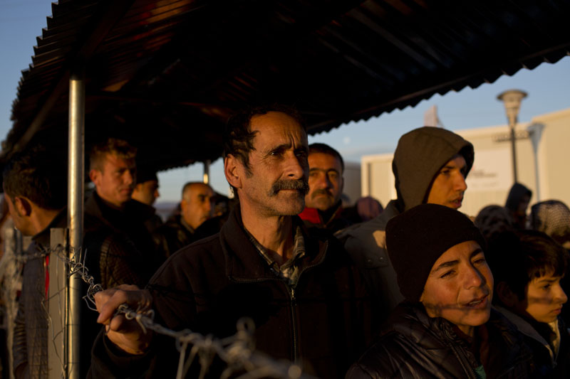 Syrian refugees stand in queue to receive food distributed by a non-governmental organisation at a refugee camp in the Greek-Macedonian border near the village of Idomeni, on Thursday, February 25, 2016. Photo: AP