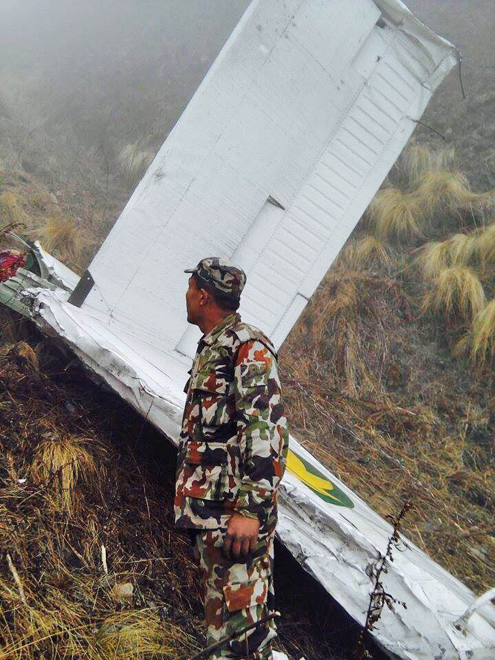 An armyman stands in front of the wreckage of Tara Air's 9N-AHH aircraft that crashed in Soli Ghoptebhir of Dana VDC in Myagdi district, on Wednesday, February 24, 2016. Photo: Nepal Army