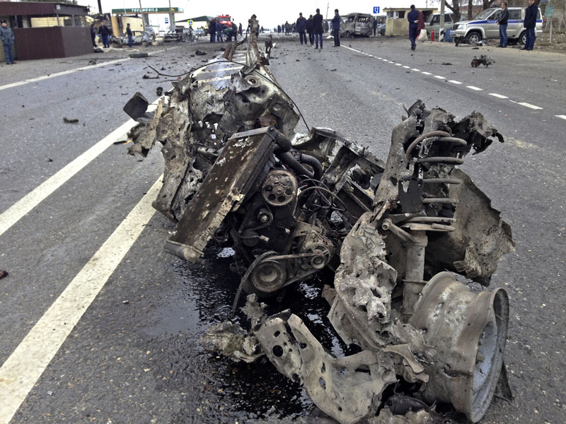 The wreckage of a suicide bomber car is seen near a traffic police check point near a village of Dzhemikent in Russian northern Caucasus region of Dagestan on Monday, February 15, 2016. Photo: Bashir Aliev/ NewsTeam photo via AP