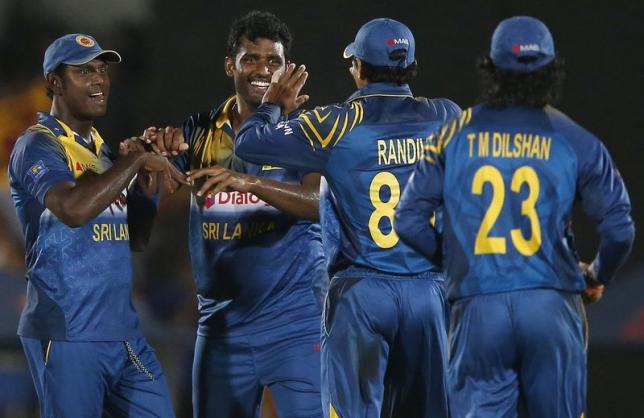 Sri Lanka's Thisara Perera (2nd L) celebrates with captain Angelo Mathews (L), Suraj Randiv (2nd R) and Tillakaratne Dilshan after taking the wicket of Pakistan's Fawad Alam (not pictured) during their second ODI (One Day International) cricket match in Hambantota August 26, 2014.  REUTERS/Dinuka Liyanawatte