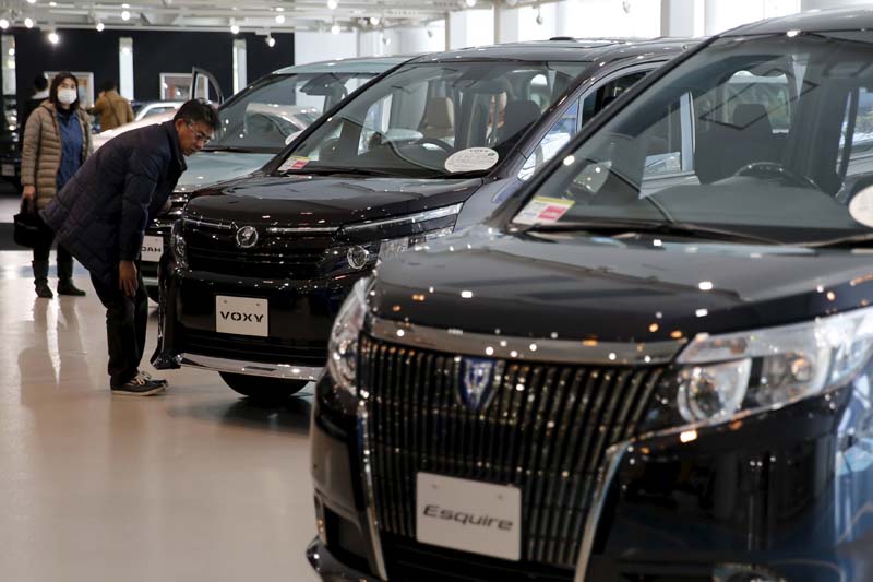 A man looks at Toyota Motor Corp's cars at the company's showroom in Tokyo, Japan on February 5, 2016. Photo: Reuters