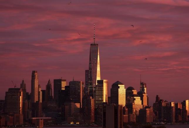 The setting sun reflects off of One World Trade Center and surrounding buildings at sunset in the Manhattan borough of New York City, November 22, 2015. REUTERS/Rickey Rogers/Files