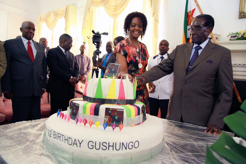 Zimbabwean President Robert Mugabe (right) and his wife Grace cut his birthday cake at State House at State House in Harare, on Monday, February 22, 2016. Photo: AP