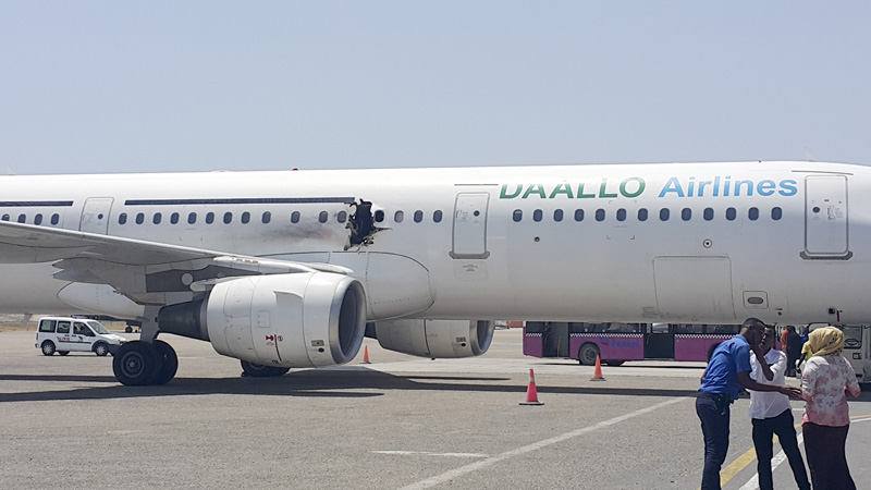 In this photo taken Tuesday, Feb. 2, 2016, a hole is seen in a plane operated by Daallo Airlines as it sits on the runway of the airport in Mogadishu, Somalia. Photo: AP