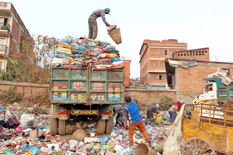 Labourers collect and stack garbage into a truck in Minbhawan, Kathmandu on Friday, February 26, 2016. Photo: RSS