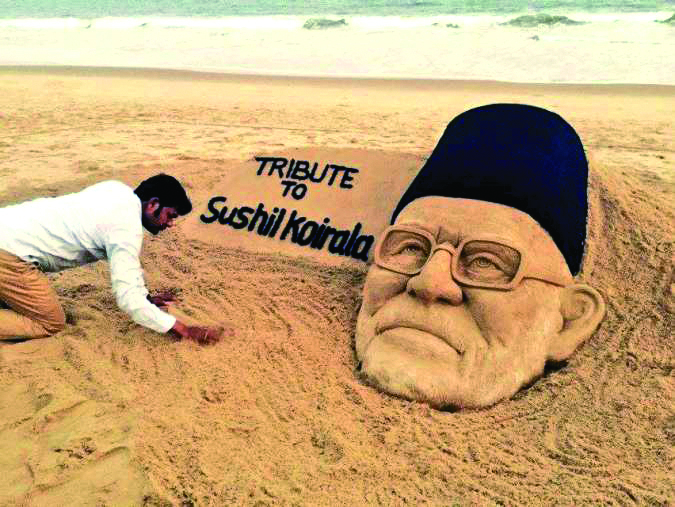 An indian artist pays his respect to late PM Sushil Koirala by making his portrait with sand in beach in India on Tuesday, February 9, 2016. Photo: THT