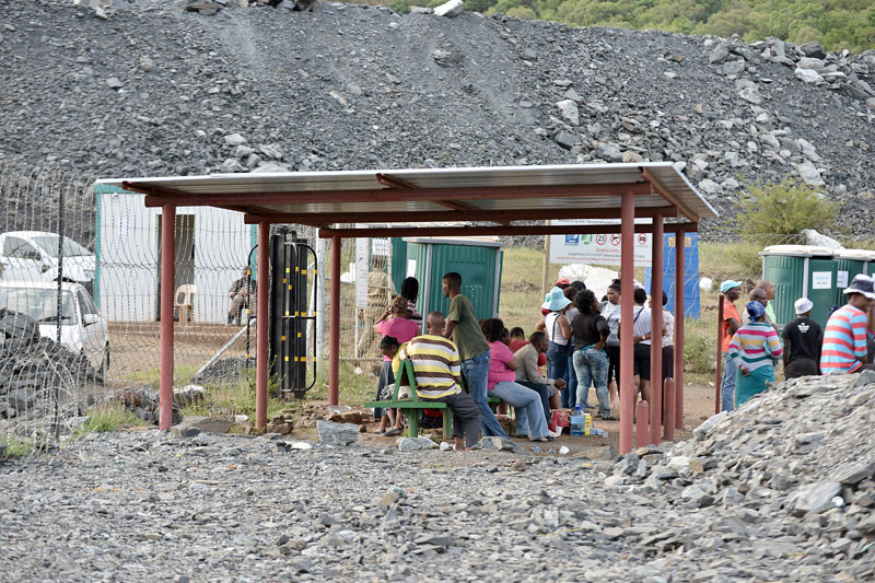 Concerned family members and friends of three missing persons wait outside the Vantage Goldfields Limited's Lily Mine's entrance near Barberton, South Africa, on Friday February 5, 2016. Photo: AP