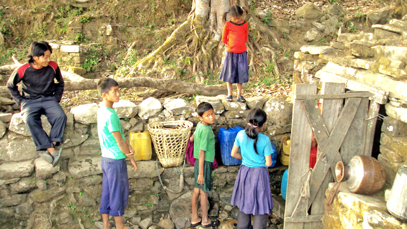 Schoolgoing children waiting for their turn to fill  water pots at Aalital VDC in Dadeldhura on Monday. The children miss their classes for a pot of water, on Monday, February 29, 2016. Photo: THT