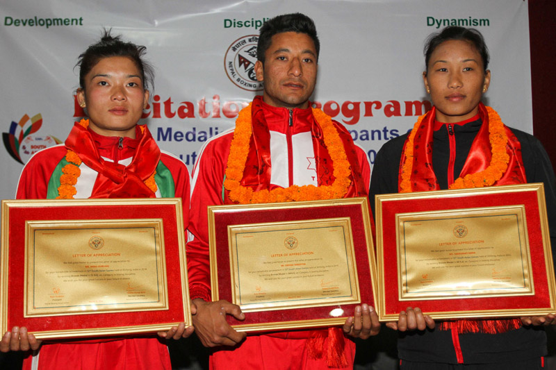 (From left) The 12th South Asian Games bronze medal winning boxers Minu Gurung, Deepak Shrestha and Saraswoti Rana after being felicitated by Nepal Boxing Association on Thursday. Photo: THT
