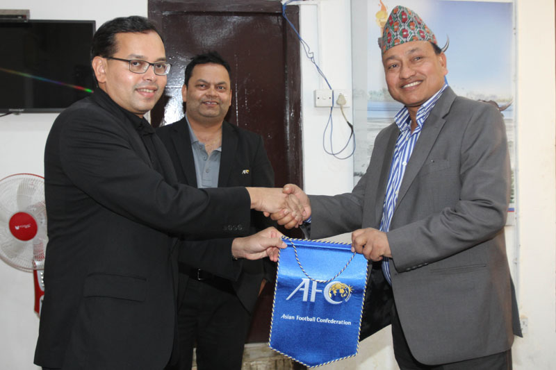 AFC Director of Member Associations Sanjeevan Balasingam (left) shakes hands with NSC member secretary Keshab Bista as AFC International Relations Officer Purushottam Kattel looks on before a meeting in Kathmandu on Thursday. Photo: Udipt Singh Chhetry/THT