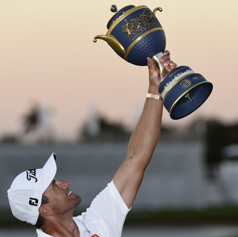 Australia's Adam Scott holds  the trophy after winning the WGC-Cadillac Championship at the Trump National Doral Resort in Miami on Sunday. Photo: Reuters