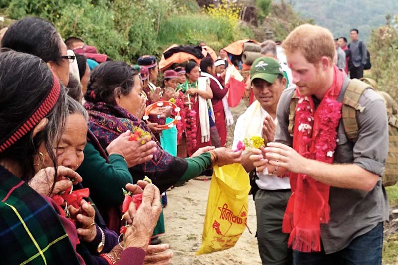 Britain's Prince Harry accepts flowers and blessings from local elderly women in Leurani hamlet during his visit to the Bardiya National Park, on Monday, March 21, 2016. Photo: Kensington Palace