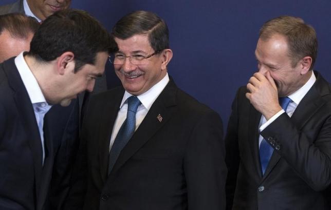 Greek Prime Minister Alexis Tsipras (L), Turkish Prime Minister Ahmet Davutoglu (C) and European Council President Donald Tusk attend a group photo during a EU-Turkey summit in Brussels, as the bloc is looking to Ankara to help it curb the influx of refugees and migrants flowing into Europe, March 7, 2016. REUTERS/Yves Herman