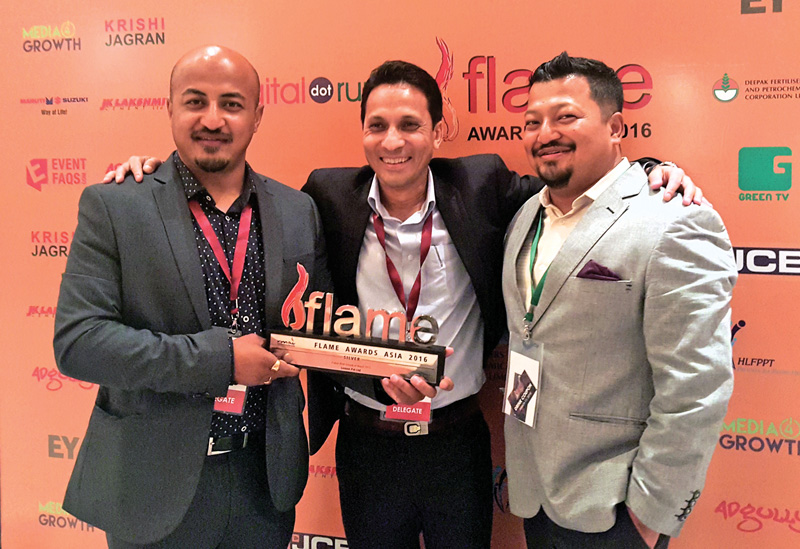 A file photo of Ujjwal Shakya, MD of Lemon Pvt Ltd, Abhaya Pd Gorkhalee, head of marketing at Dabur Nepal, and Ujaya Shakya, MD of Outreach Nepal, posing with the Flame award, in New Delhi.  Photo: THT