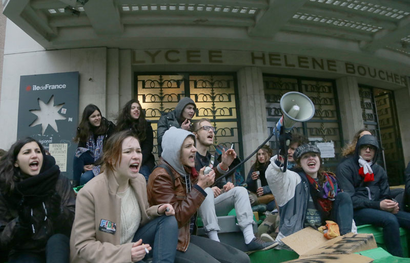 Students  shout slogans outside their high school in Paris, on Wednesday , March 9, 2016. Photo: AP