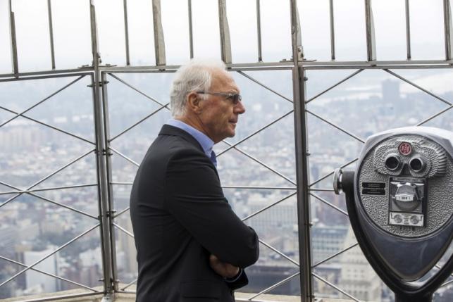 Soccer legend Franz Beckenbauer pauses to look out on the city on top of the Empire State Building during an event to celebrate the start of the New York Cosmos 2015 season, in New York April 17, 2015. REUTERS/Lucas Jackson