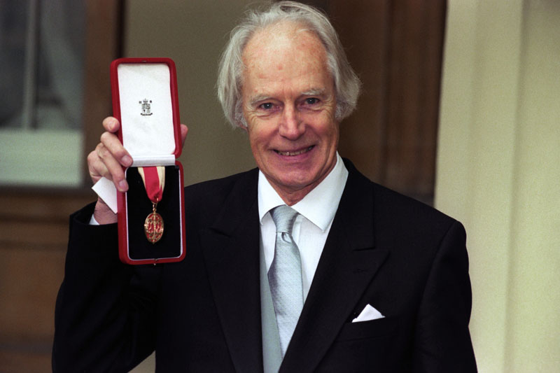FILE - Sir George Martin poses for the media with his knighthood at Buckingham Palace, London, on November 12, 1996. Photo: Neil Munns/PA via AP