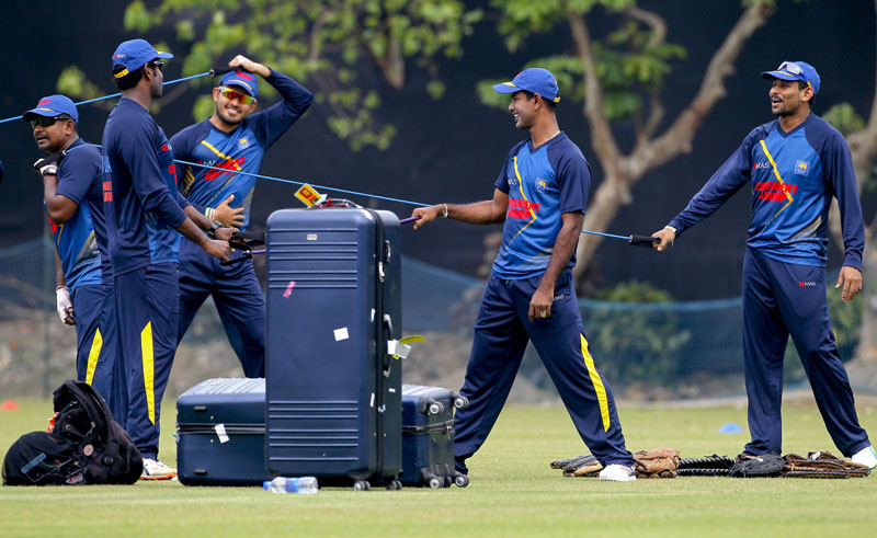 Sri Lanka's Rangana Herath (left) Angelo Mathews (second left) Tillakaratne Dilshan, right and Nuwan Kulasekara (second right) stretch prior to their practice match of the ICC World Twenty20 2016 cricket tournament in Kolkata, India, on Saturday, March 12, 2016. Photo: AP