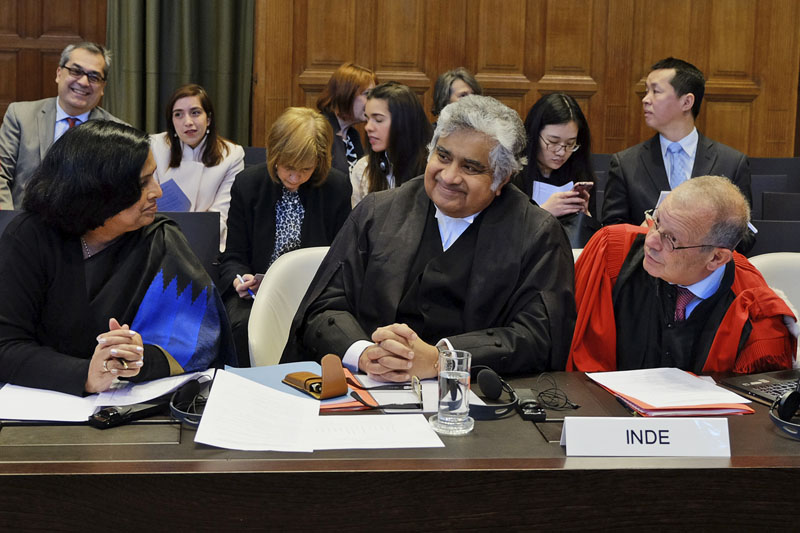 Members of the Indian delegation Neeru Chadha (left) Harish Salve (centre) and Alain Pellet (right) wait for the start of a preliminary hearing on nuclear disarmament at the International Court of Justice in The Hague, Netherlands, on Monday, March 7, 2016. Photo: AP