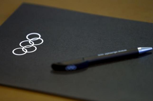 A folder and a pen are pictured on a table before the start of the Executive Board meeting at the International Olympic Committee (IOC) headquarters in Lausanne, Switzerland December 8, 2015. REUTERS/Denis Balibouse/Files