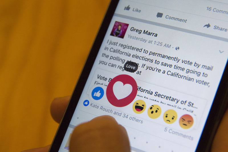 FILE - Julie Zhuo, product design director at Facebook, demonstrates the new emoji icons, on February 18, 2016. Photo: AP