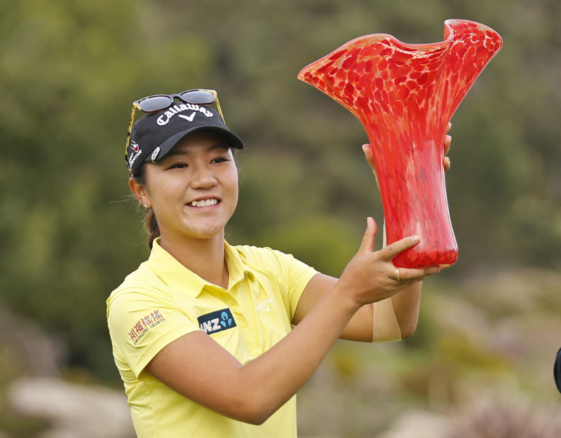 Lydia Ko, from New Zealand, holds up the winner's trophy after her four shot victory at the Kia Classic women's golf tournament Sunday, March 27, 2016, in Carlsbad, California. Photo: AP