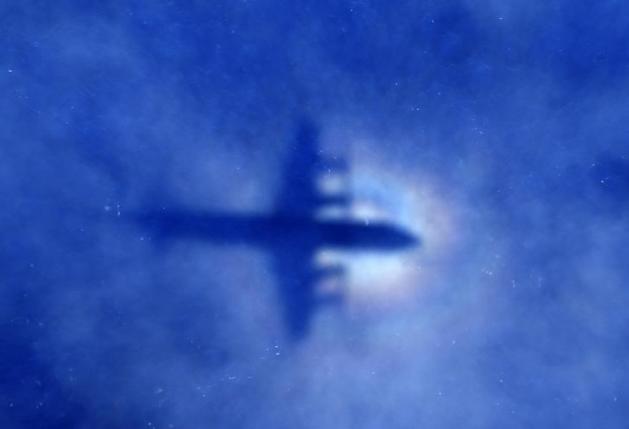 The shadow of a Royal New Zealand Air Force (RNZAF) P3 Orion maritime search aircraft can be seen on low-level clouds as it flies over the southern Indian Ocean looking for missing Malaysian Airlines flight MH370 March 31, 2014. REUTERS/Rob Griffith/Pool/Files