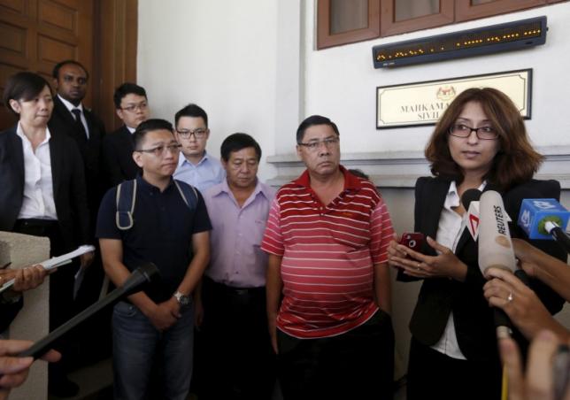 Lawyer Sangeet Deo (R) speaks to members of the media, accompanied by relatives of passengers Tan Ah Meng, his wife Chuang Hsiu Ling, and son Tan Wei Chew, who were aboard the missing Malaysia Airlines flight MH370, during a hearing for the compensation suit brought against the Malaysian government and Malaysia Airlines over claims of negligence and breach of trust, in Kuala Lumpur, Malaysia, March 4, 2016.  REUTERS/Olivia Harris