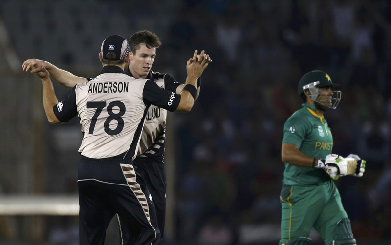 New Zealand's Adam Milne celebrates with his teammate Corey Anderson after taking the wicket of Pakistan's Umar Akmal during ICC World Twenty20 Cricket tournament in Mohali, India on Tuesday, March 22, 2016. Photo: Reuters