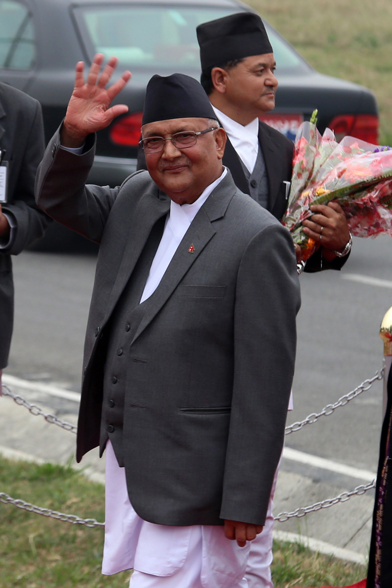 Prime Minister KP Sharma Oli waves as he lands at the Tribhuvan International Airport from China, in Kathmandu, on Sunday, March 27, 2016. Photo: RSS