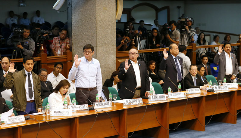 Standing from left, East West Bank branch manager Allan Penalosa, Michael Bautista of the Philrem Services Corporation, Philippine Amusement and Gaming Corporation COO Eugene Manalastas, counsel Victor Fernandez and idas Hotel and Casino director Bienvenido Santiago, onThursday, March 17, 2016 take their oaths prior to the start of the Philippine Senate probe into how about $81 million of Bangladesh's stolen funds were transmitted online to four private accounts at a branch of the Rizal Commercial Banking Corp. in suburban Pasay city, south of Manila, Philippines. Photo: AP