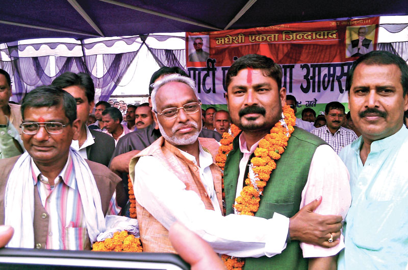 Sadbhawana Party chief Rajendra Mahato welcoming a new member into his party, in Rautahat, on Saturday. Photo: THT
