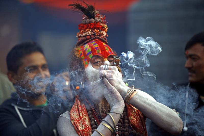 A Hindu Sadhu smokes marijuana in a chillum inside the Pashupatinath Temple on the occasion of Mahashivaratri premise in Kathmandu, Nepal on Monday, March 7, 2016. Photo: Skanda Gautam/ THT