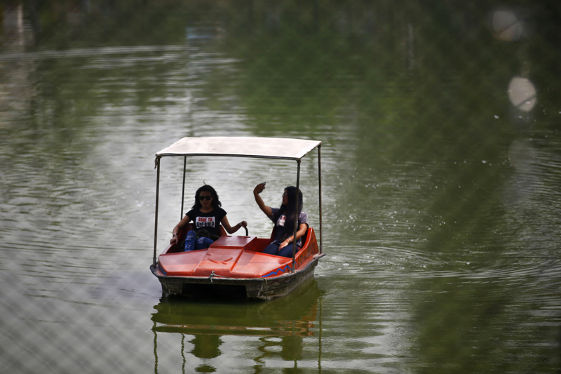 Women ride a boat at the Central Zoo in Lalitpur, on Friday, March 25, 2016. Photo: Skanda Gautam
