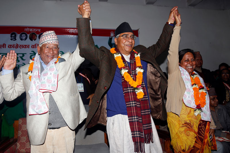 Sher Bahadur Deuba flanked by leaders Arjun Narsingh KC and Chitra Lekha Yadav waves to his supporters during the candidacy announcement programme at the party headquarters in Sanepa on Thursday, March 03, 2016. Photo: RSS 