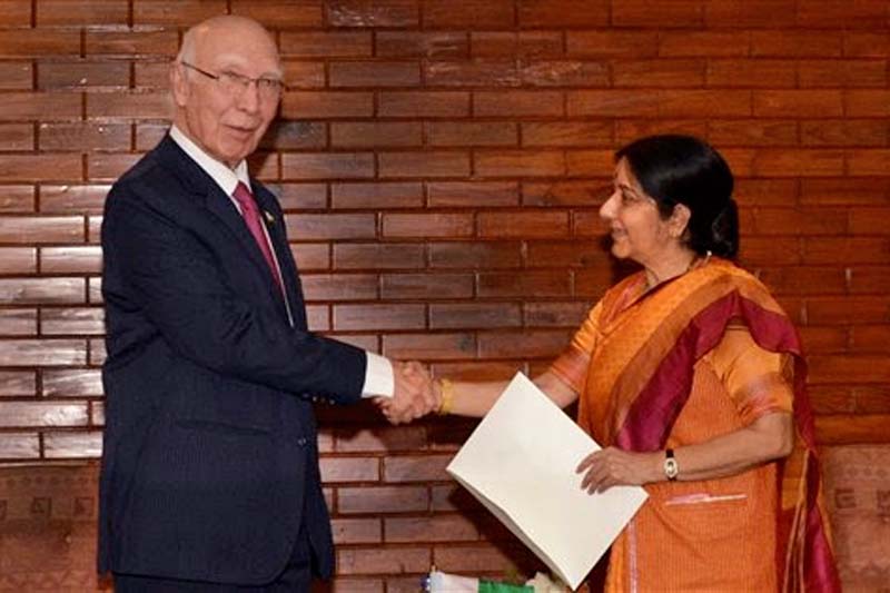 Indian Foreign Minister Sushma Swaraj (right) shakes hand with Pakistan Foreign Affairs Adviser Sartaj Aziz during the 37th South Asian Association for Regional Cooperation (SAARC) Council of Ministers' Meeting in Pokhara, on Thursday, March 17, 2016. Photo: Krishna Mani Baral via AP