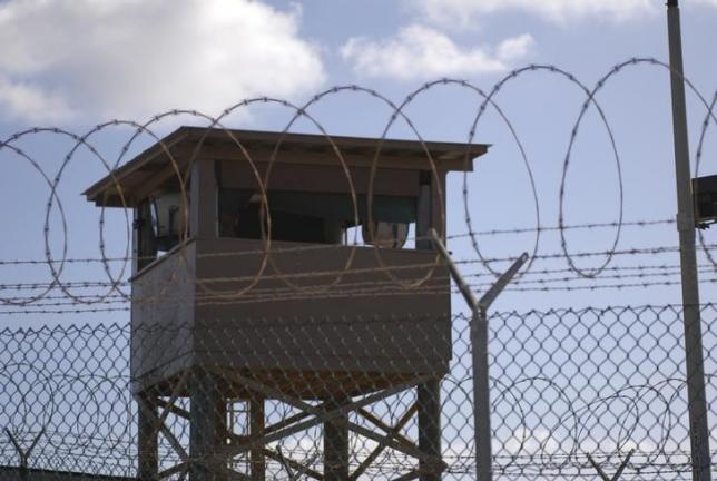 A soldier stands guard in a tower overlooking Camp Delta  at Guantanamo Bay naval base in a December 31, 2009 file photo provided by the US Navy. REUTERS/US Navy/Spc. Cody Black/Handout via Reuters