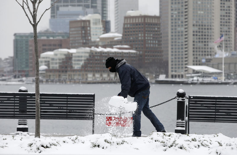 Daniel Cardona clears snow from a sidewalk in the East Boston neighborhood of Boston, on Monday, March 21, 2016. Photo: AP