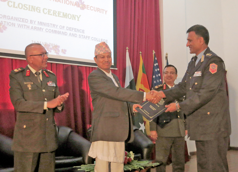 Minister for Defense Bhim Rawal congratulates SSP Ramesh Kharel upon completion of the nine days High Level Security Training organised by Staff College in Shivapuri on Monday, March 21, 2016. Photo: RSS