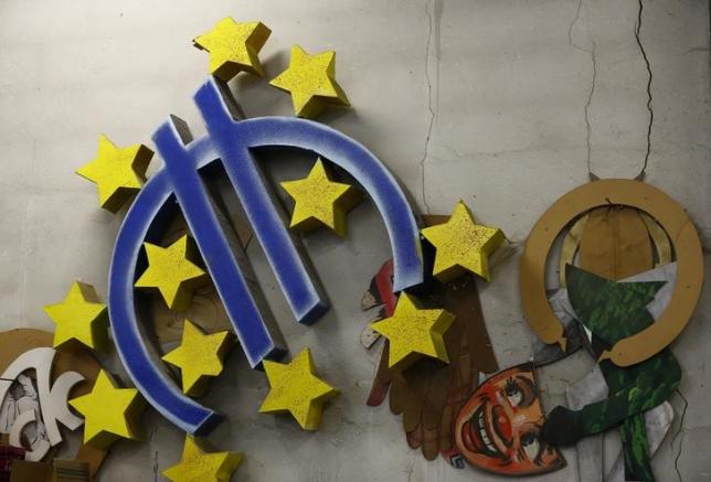 A carnival float euro sign decoration, leftover from previous years, hangs on a wall in a carnival workshop in Mainz, Germany February 2, 2016. REUTERS/Kai Pfaffenbach